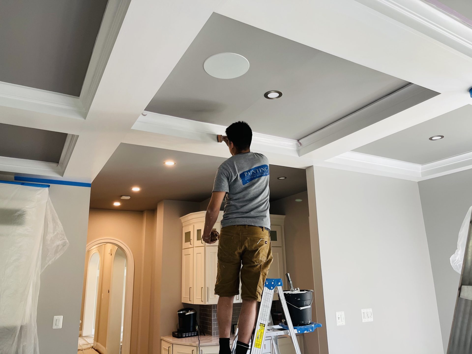 employee of painting contractors of MD coffered ceiling refresh with sherwin williams paint