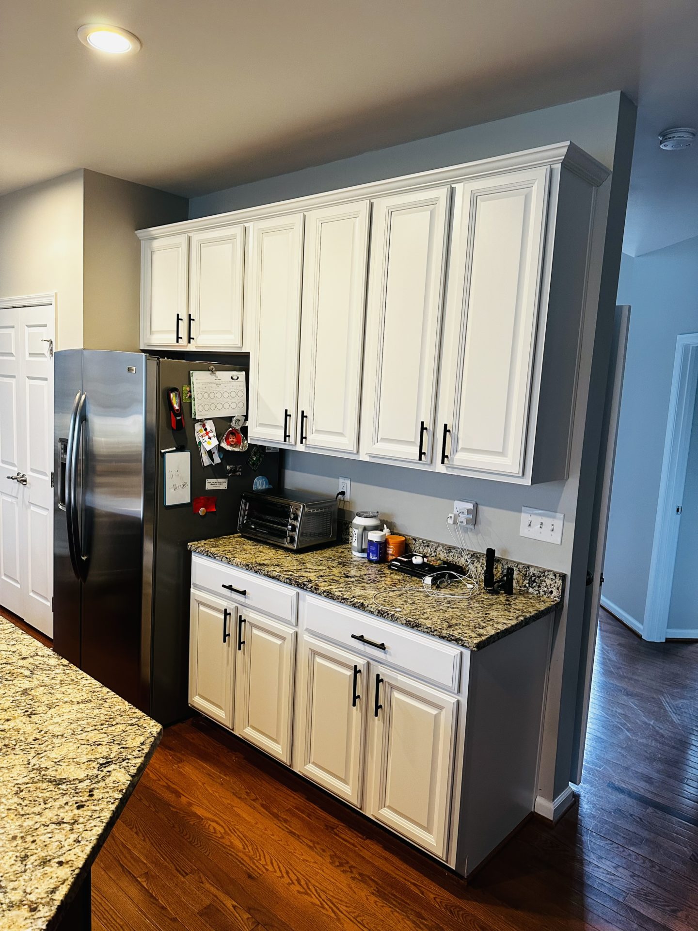 Transformed kitchen cabinets with a fresh coat of paint.