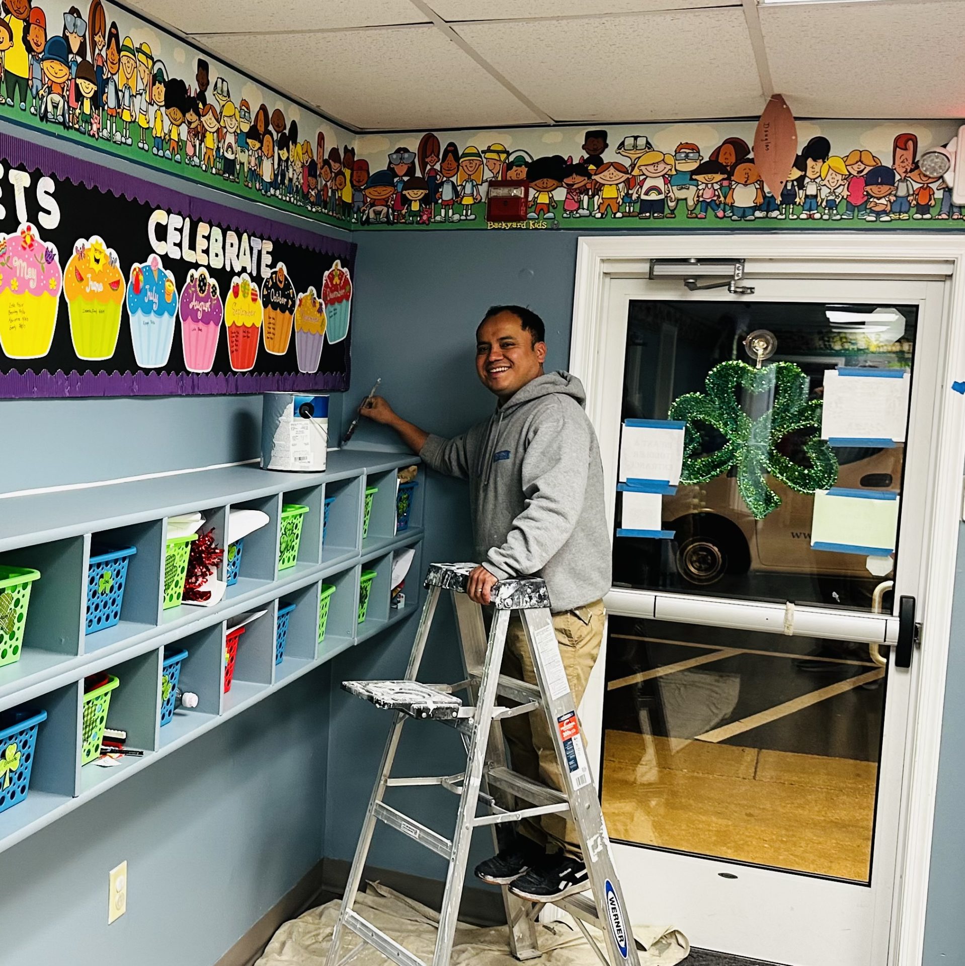 Professional painter working on refreshing the interior paint at The Playtime Daycare