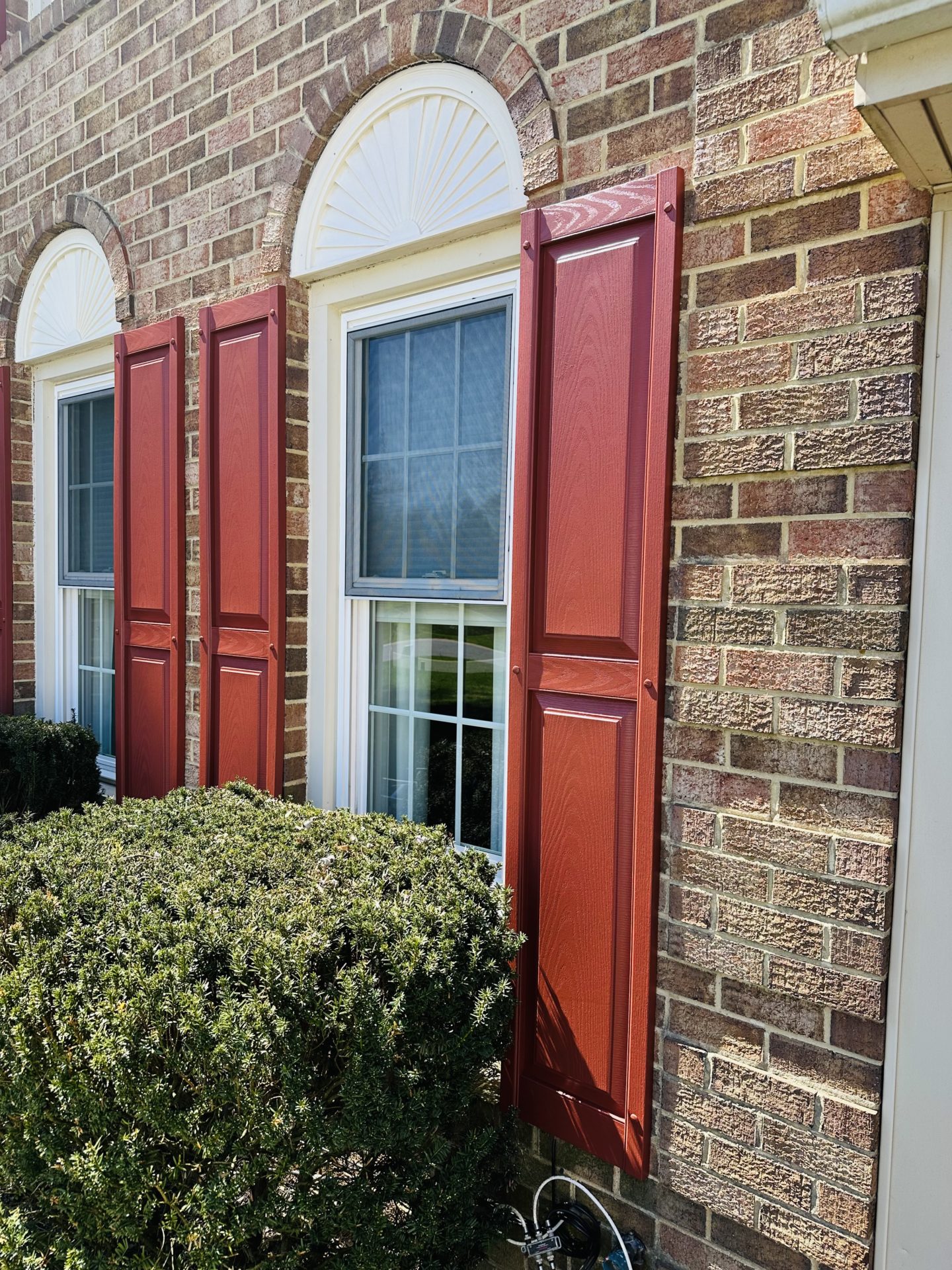 Revitalized vinyl shutters painted in a fresh coat, adding visual appeal to the home's exterior