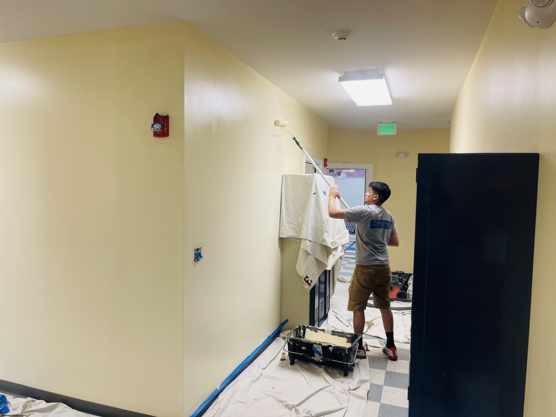 Professional painter revitalizing a school environment, creating a fresh and inviting atmosphere