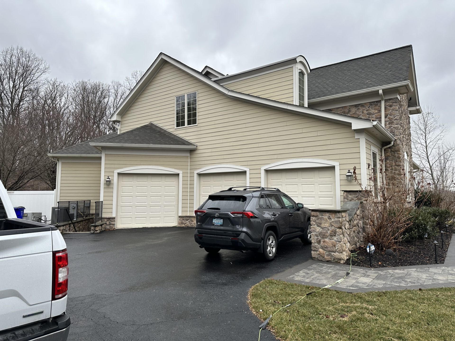 The outdated tan siding ready for a refreshing change.